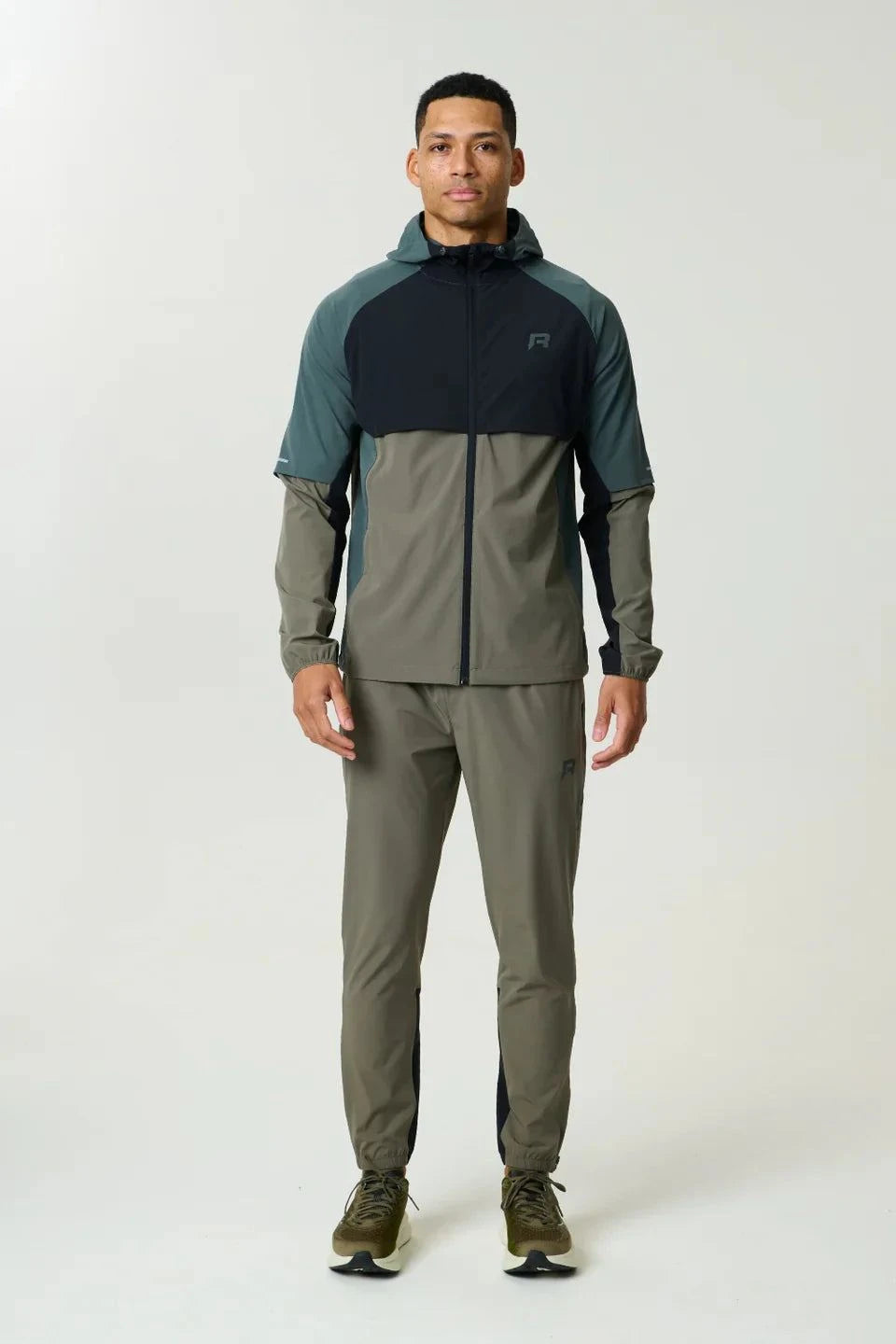 Reprimo Vortex Windbreaker in Dark Moss and Grey Velvet with ergonomic panels and reflective details