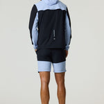 Man wearing black and dusky sky Reprimo Flight Windbreaker with hood and zip pockets, paired with matching shorts