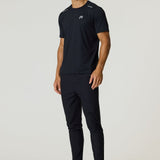 Male model wearing black Reprimo Flight Pants with reflective strips and functional pockets, paired with black athletic shirt and shoes.
