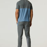 Man wearing Reprimo Flight Pants in Air Force Blue and Gunmetal with breathable, lightweight design and reflective strips for enhanced visibility.