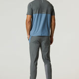 Man wearing Reprimo Flight Pants in Air Force Blue and Gunmetal with breathable, lightweight design and reflective strips for enhanced visibility.