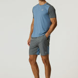 Man wearing Reprimo Flight Shorts in Air Force Blue and Gunmetal with breathable fabric and secure side pockets.