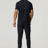 Rear view of a man wearing a black Reprimo Flight T-Shirt with reflective strips and athletic fit, paired with black workout pants.