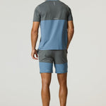 Man wearing Reprimo Flight T-Shirt in Air Force Blue and Gunmetal with matching shorts, showing back view.