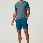 Athletic man wearing Reprimo Flight Shorts in tidal teal and blue steel with matching t-shirt and sneakers.