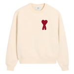 Cream AMI Paris sweatshirt with red Ami De Coeur patch on chest