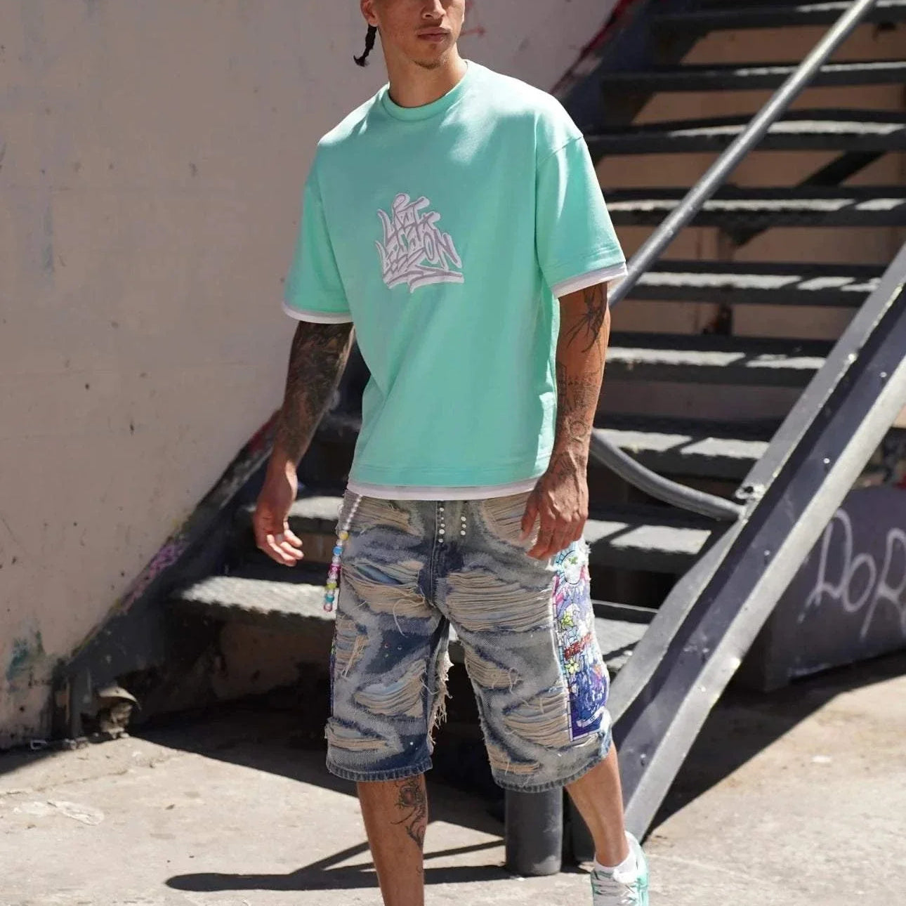 Last Lesson Graffiti 3 Layer T-Shirt in vibrant urban setting.