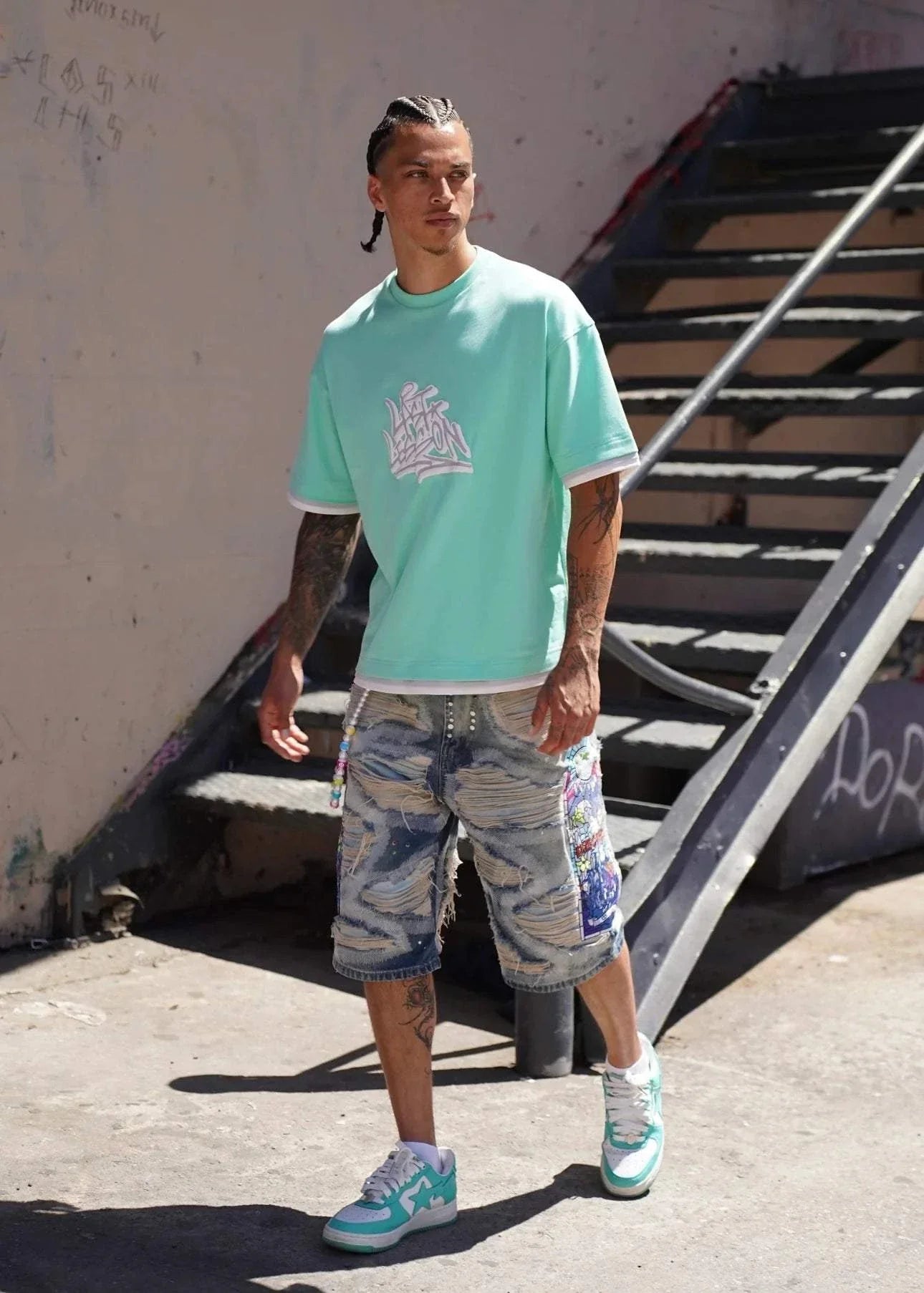 Last Lesson Graffiti 3 Layer T-Shirt in vibrant urban setting.