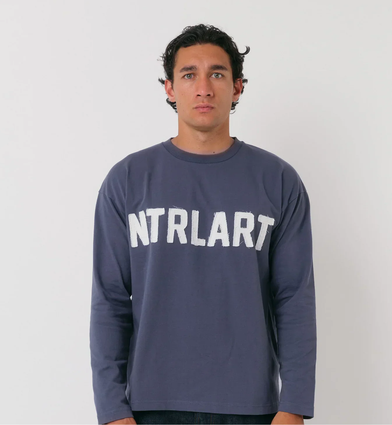 Natural Art Studio navy long sleeve cotton top with distressed appliqué logo and boxy fit