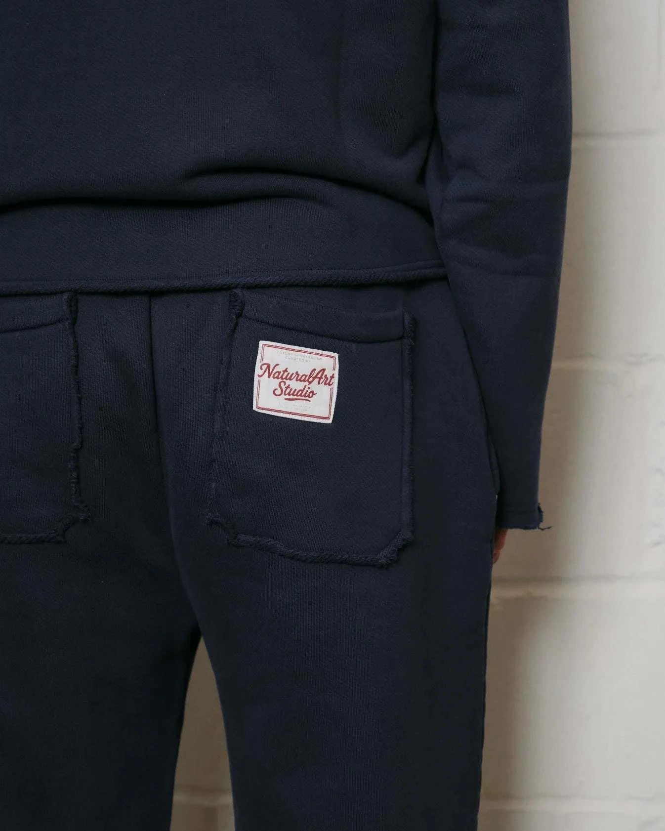 Natural Art Studio navy cotton applique sweatpants with elastic waistband and raw edges