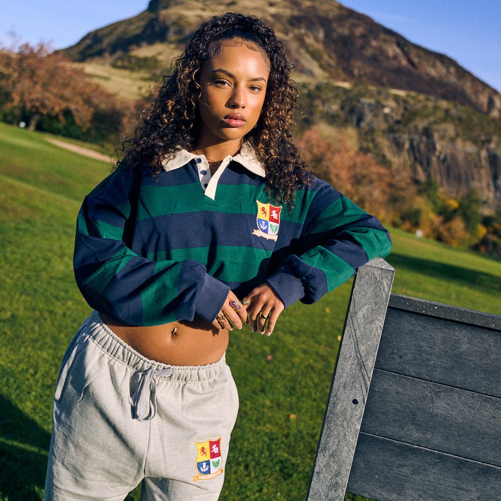 Woman wearing Five Questions Rugby polo shirt outdoors near hillside