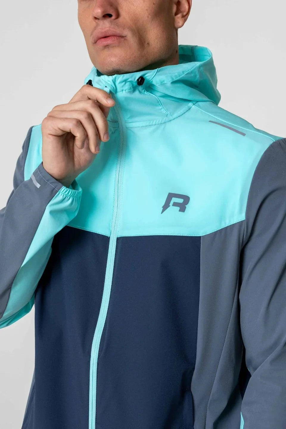 Reprimo Flight windbreaker in cyan and navy.