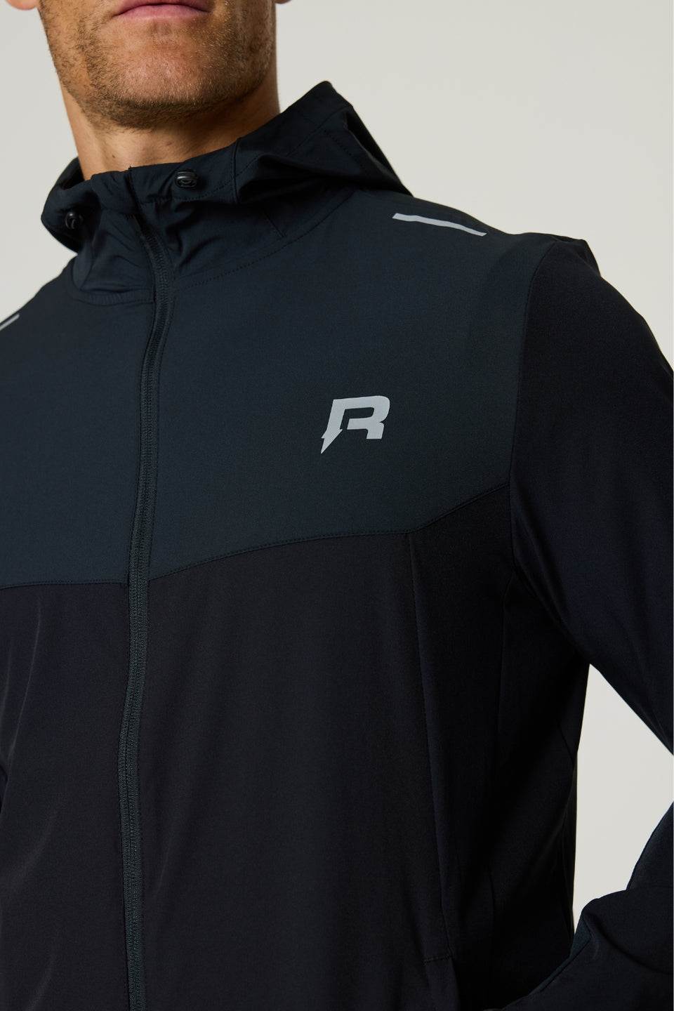 Reprimo Flight Windbreaker in black with meteorite accents, lightweight polyamide fabric, zip pockets, and back vent for breathability