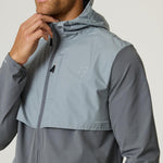 Man wearing slate and light grey Reprimo Summit Windbreaker jacket with hood and zip front