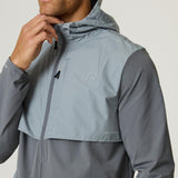 Man wearing slate and light grey Reprimo Summit Windbreaker jacket with hood and zip front