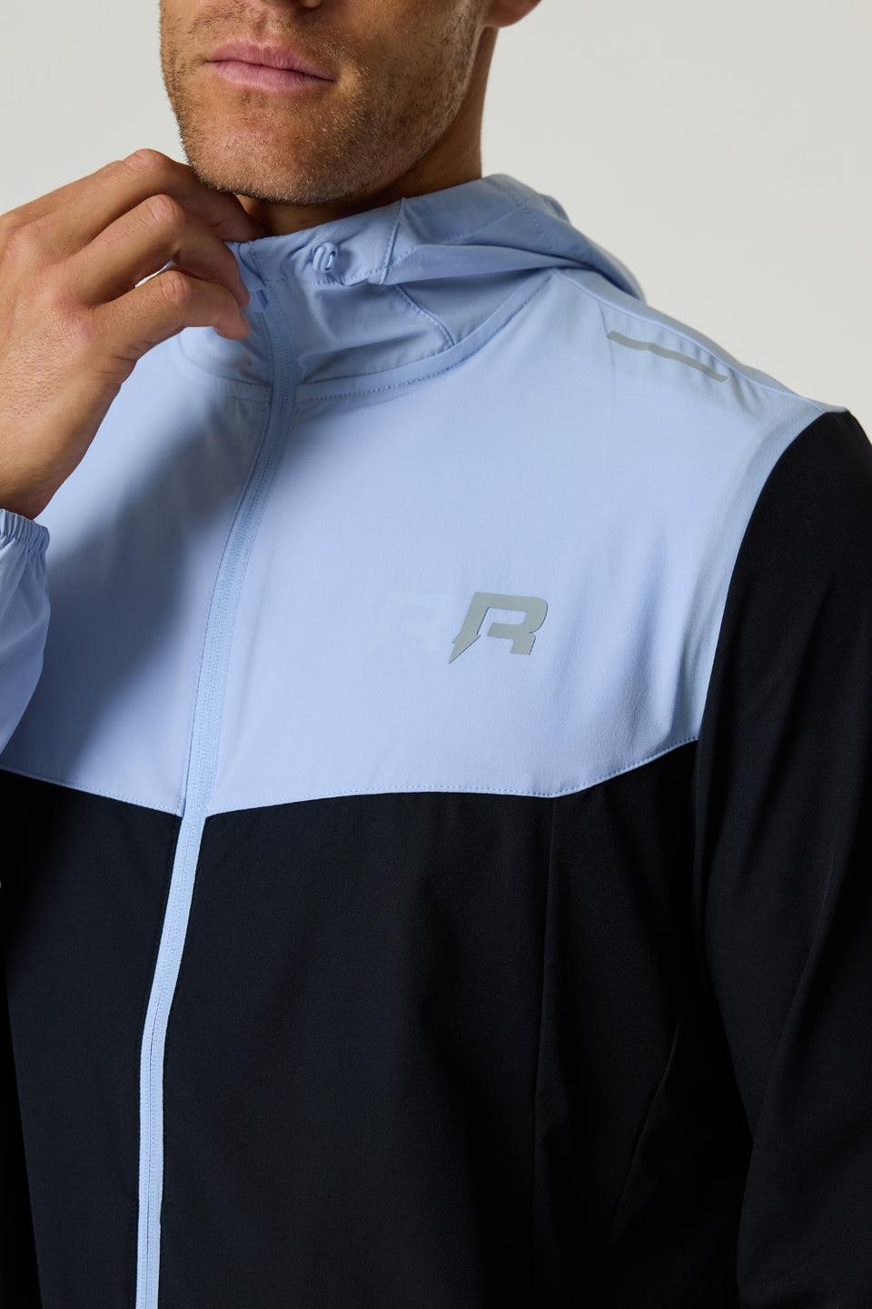 Reprimo Flight Windbreaker in black and dusky sky with lightweight, wind-resistant design and zip pockets for outdoor activities