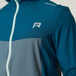 Reprimo Flight Windbreaker in tidal teal and blue steel with lightweight, wind-resistant polyamide fabric, zip pockets, and breathable back vent.