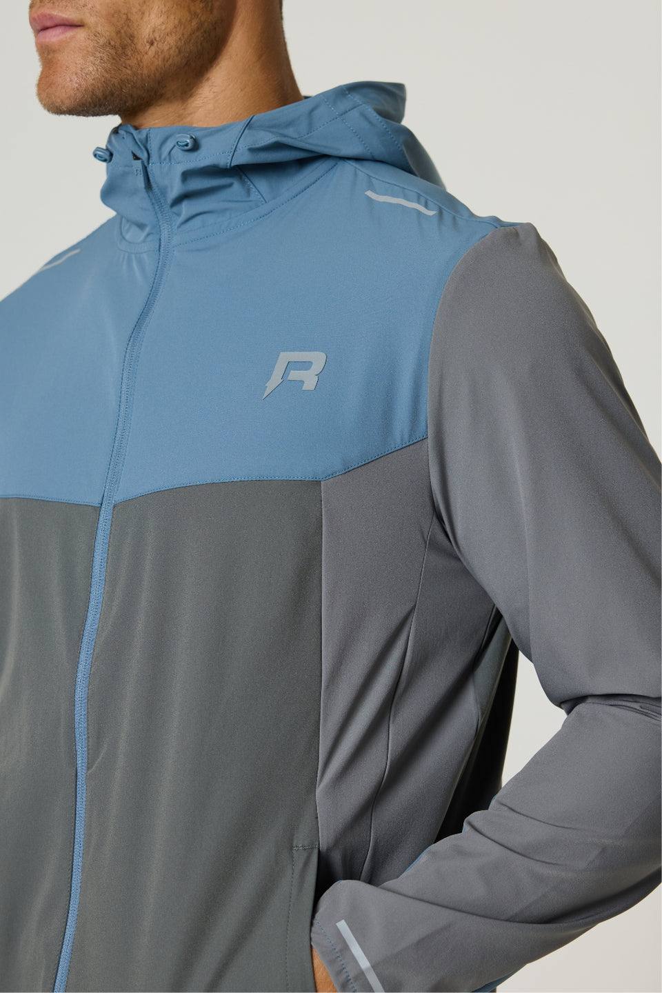 Reprimo Flight Windbreaker in Air Force Blue and Gunmetal, lightweight weather-resistant jacket with zip pockets and breathable back vent.