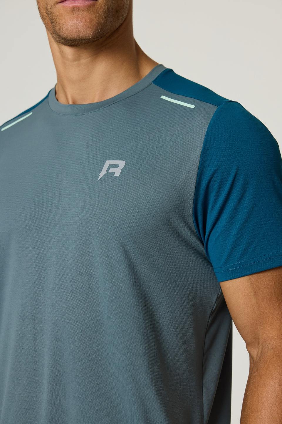 Reprimo Flight T-Shirt in tidal teal and blue steel with lightweight, breathable fabric and reflective strips for athletic performance and safety.