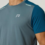 Reprimo Flight T-Shirt in tidal teal and blue steel with lightweight, breathable fabric and reflective strips for athletic performance and safety.