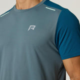Reprimo Flight T-Shirt in tidal teal and blue steel with lightweight, breathable fabric and reflective strips for athletic performance and safety.