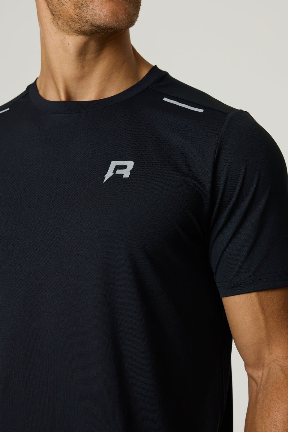 Black Reprimo Flight T-Shirt with lightweight, breathable fabric and reflective strips for athletic performance.