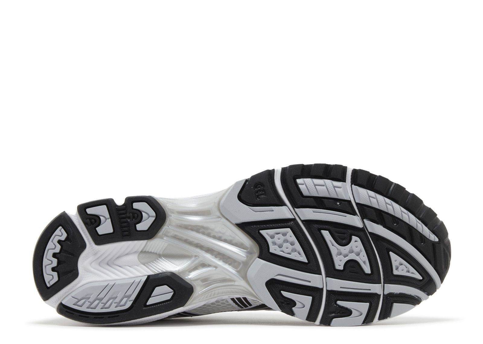Gel Kayano 14 running shoe sole in white and black with Tai-Chi yellow accents
