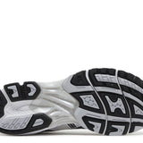 Gel Kayano 14 running shoe sole in white and black with Tai-Chi yellow accents