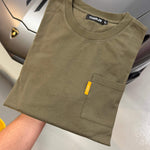 Studio By Charles khaki long sleeve tee with front pocket folded on car hood background
