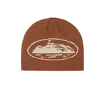 Corteiz Alcatraz Beanie Brown hat with oval design.