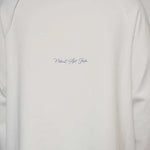 Natural Art Studio white cotton long sleeve shirt with distressed appliqué and screen print logo