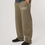 Natural Art Studio vintage wash green cotton sweatpants with faded logo and metal rivets
