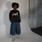 Five Questions Five Star black long sleeve tee worn by model with denim shorts and sneakers