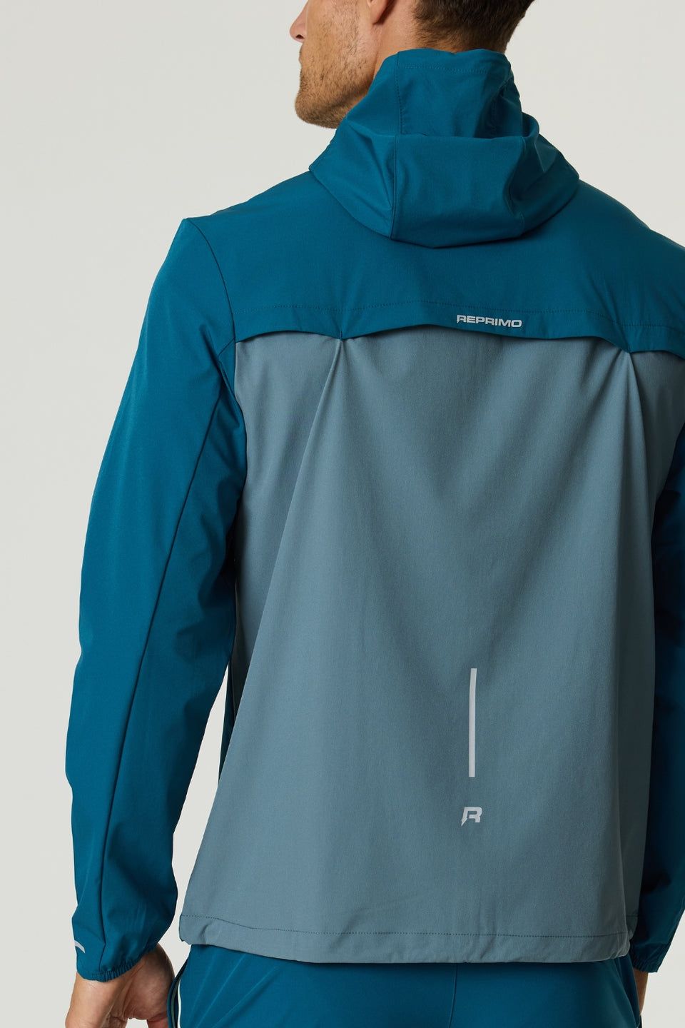 Reprimo Flight Windbreaker in tidal teal and blue steel with lightweight, durable fabric and back vent for ventilation