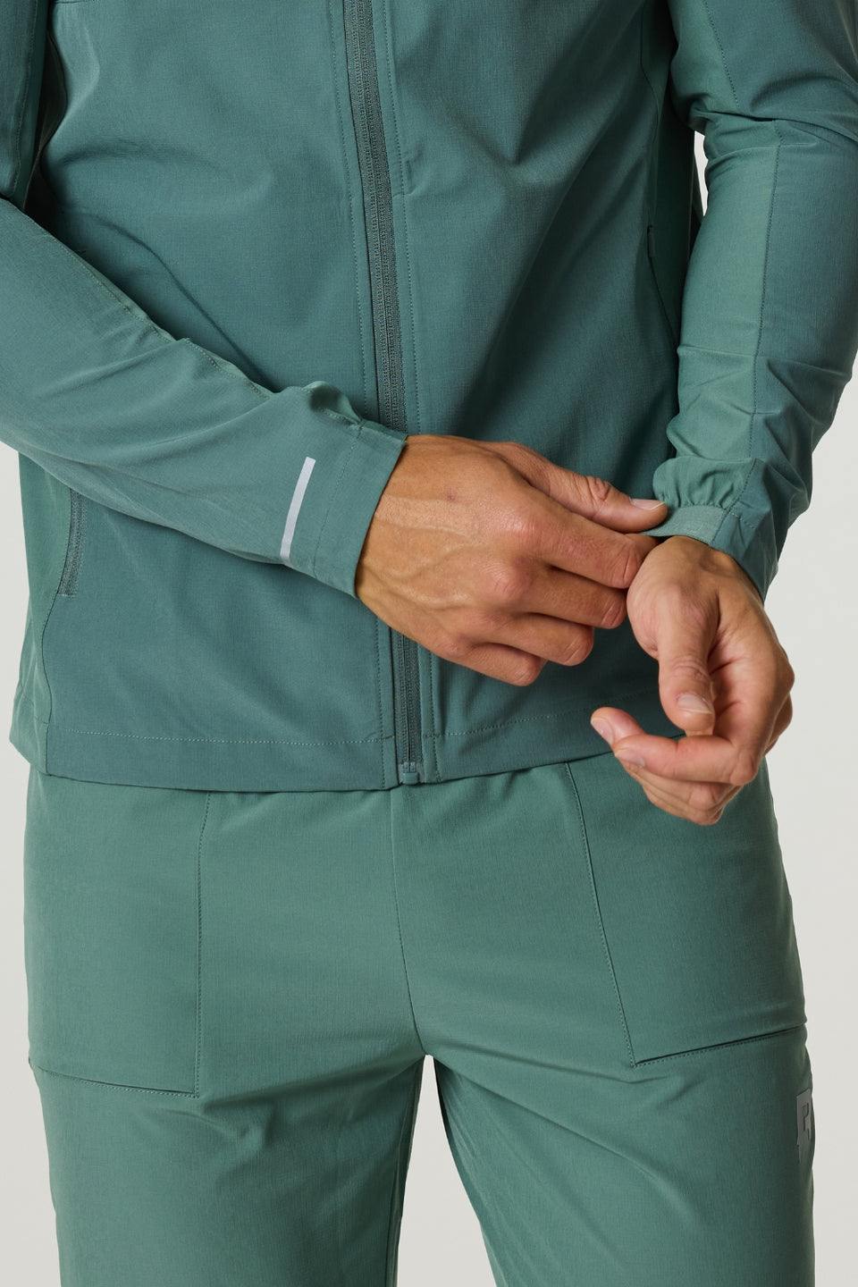 Men's Reprimo Glide Jacket in botanical pine green with front zipper and adjustable cuffs