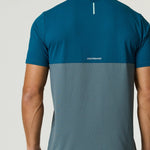 Back view of a man wearing a Reprimo Flight T-Shirt in tidal teal and blue steel with lightweight, breathable fabric and reflective strip for visibility.