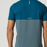 Back view of a man wearing a Reprimo Flight T-Shirt in tidal teal and blue steel with lightweight, breathable fabric and reflective strip for visibility.