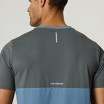 Back view of a man wearing a Reprimo Flight T-Shirt in Air Force Blue and Gunmetal with reflective strip and logo, showcasing athletic fit and lightweight breathable fabric