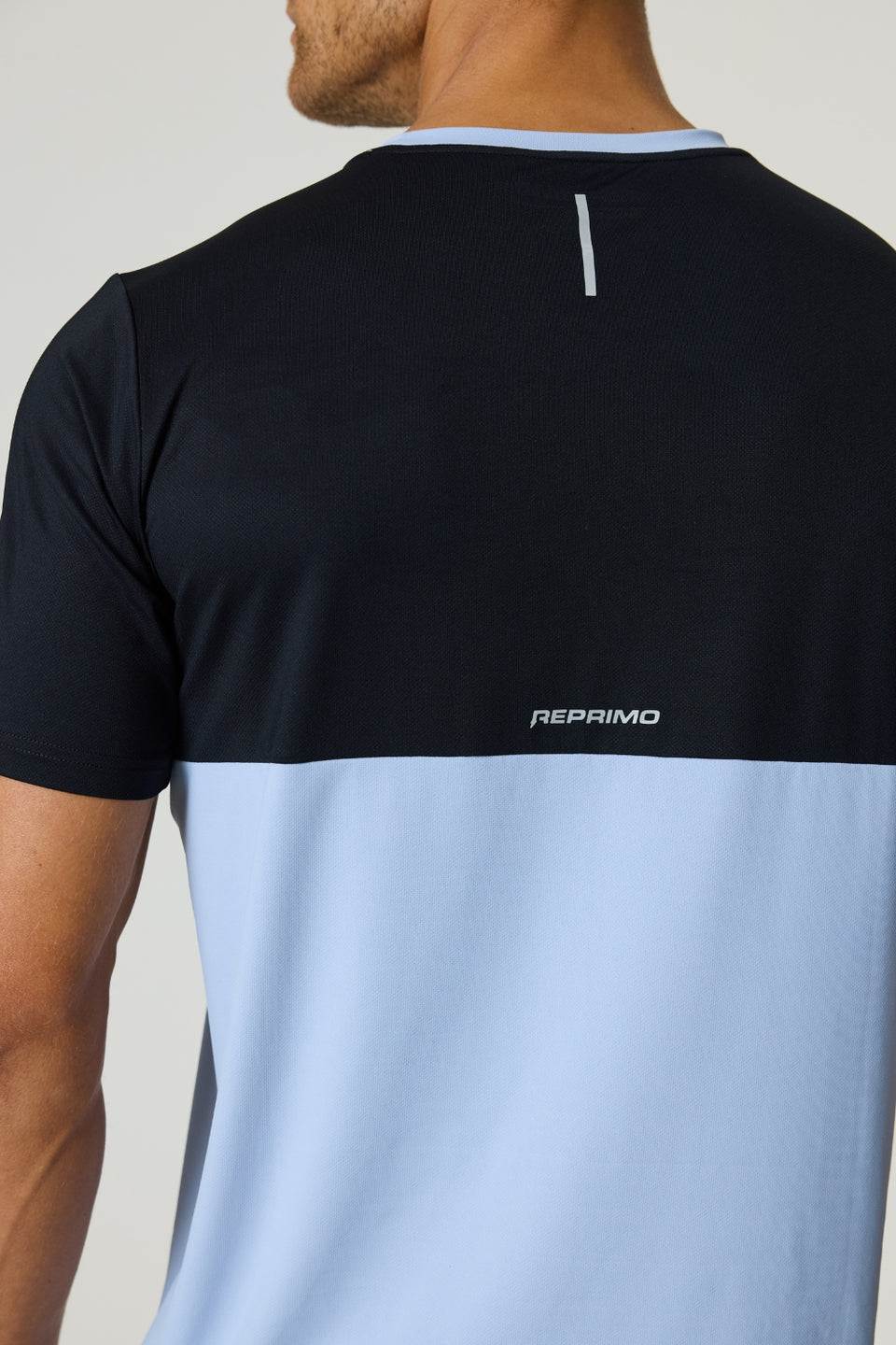 Back view of Reprimo Flight T-Shirt in black and dusky sky colors with reflective strip and logo