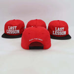 Red Last Lesson SnapBack hat with black brim and white lettering front and back