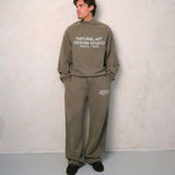 Natural Art Studio vintage wash green sweatpants with faded logo and metal rivets