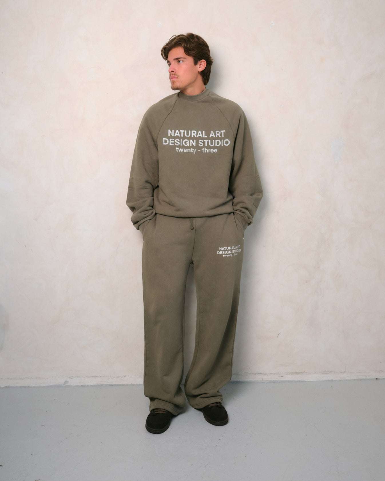Natural Art Studio vintage wash green sweatpants with faded logo and metal rivets