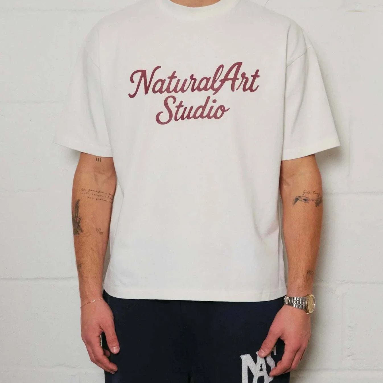 White Natural Art Studio boxy fit tee with red logo print on front and back