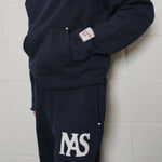 Natural Art Studio navy cotton applique sweatpants with elastic waistband and metal rivets