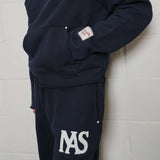 Natural Art Studio navy cotton applique sweatpants with elastic waistband and metal rivets