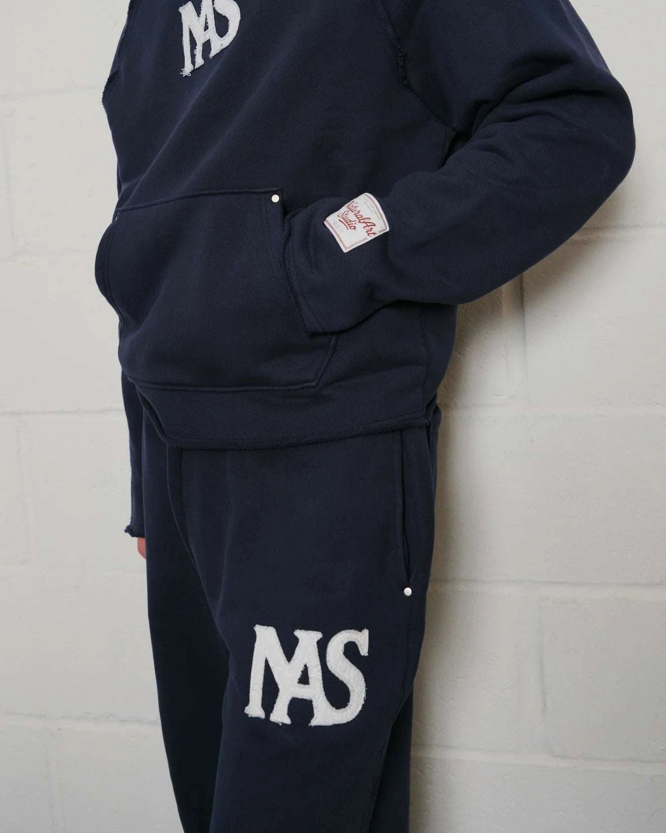 Natural Art Studio navy cotton applique sweatpants with elastic waistband and metal rivets