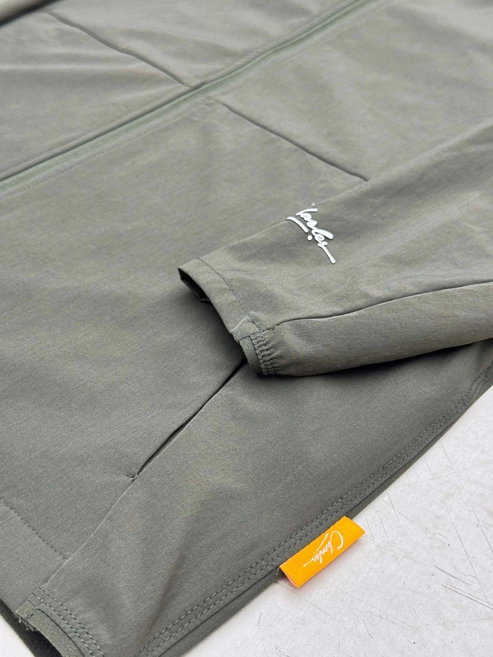 Close-up of Studio By Charles khaki lightweight track jacket sleeve and pocket detail