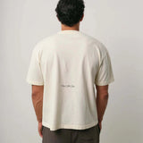 Natural Art Studio Varsity Tee in white cotton with boxy fit and dropped shoulders shown from back