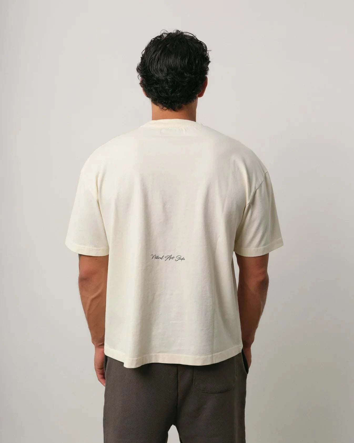 Natural Art Studio Varsity Tee in white cotton with boxy fit and dropped shoulders shown from back