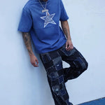 Last Lesson Blue Washed Star T-shirt worn by model with braided hair and patchwork jeans against white wall